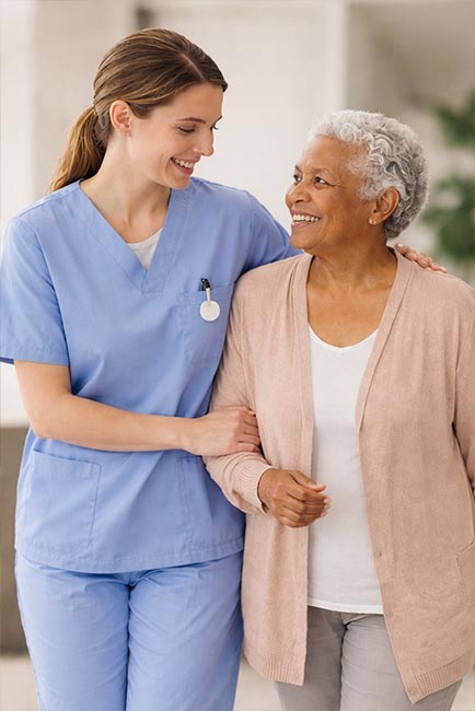 Caregiver walking with senior in a home environment